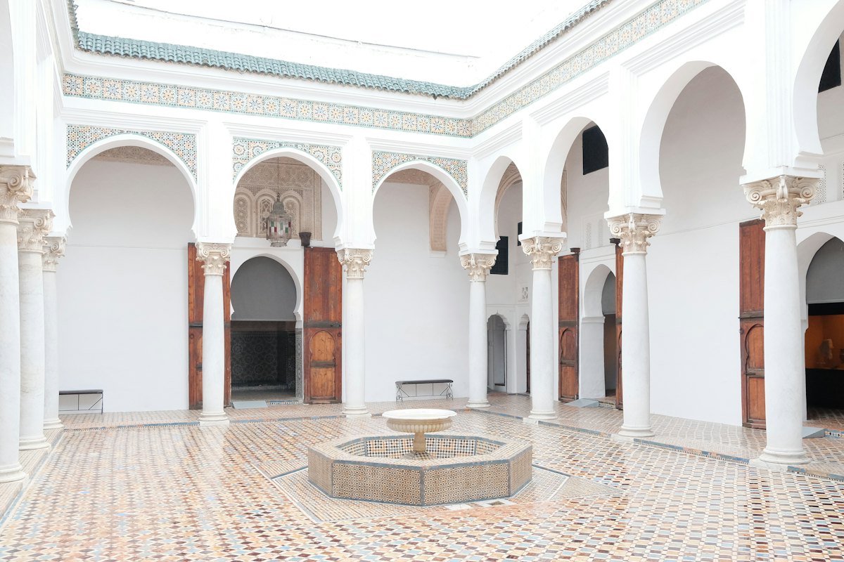 A white marble Moroccan courtyard with a fountain